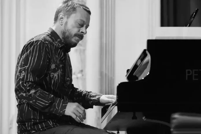 Muzičar koji svira klavijature u sali za nastup.