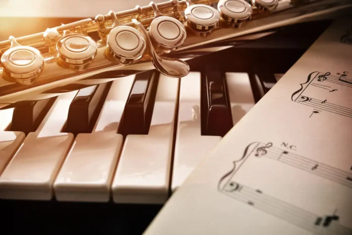 Muzički instrumenti i nota na partiturama, savršena za muzičku produkciju i izvođenje.