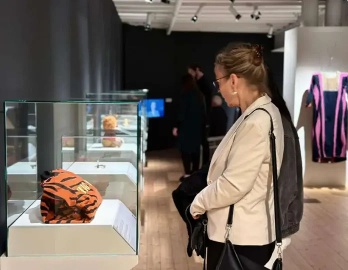 Tiger-striped Puma sports cap in glass display case at Krušnica, Bosna i Hercegovina.