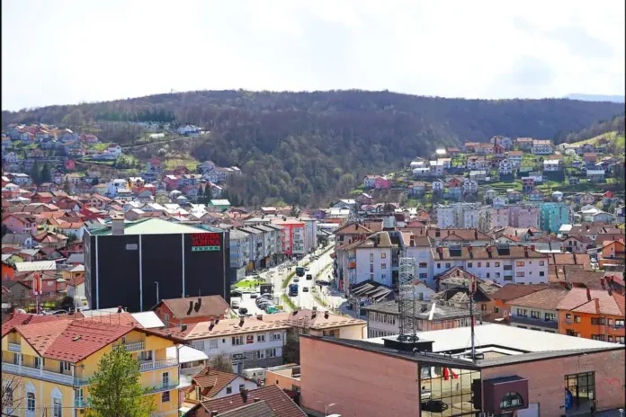 Krušnica planinski grad sa zelenim brdima i domovima u pozadini.