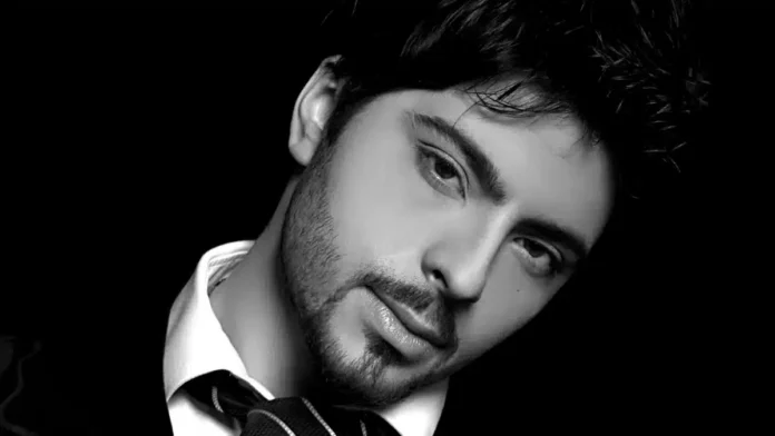 Osmiješen muškarac u crno-bijeloj fotografiji, portret s fokusom na lice.