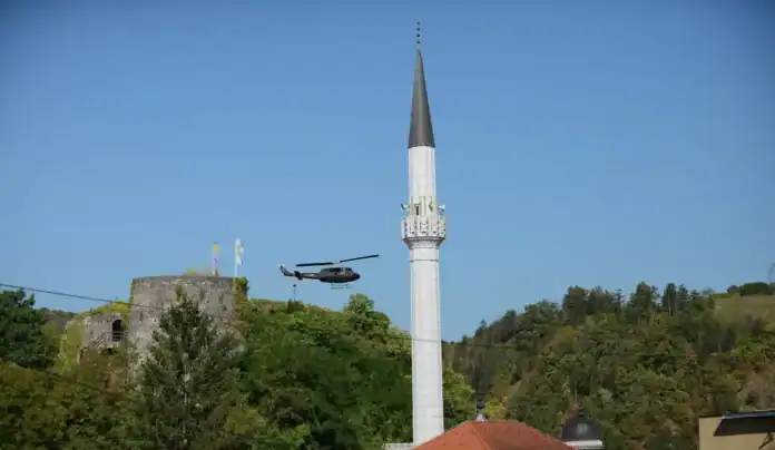 Helikopter leti pored džamije u prirodi u Bosni i Hercegovini.